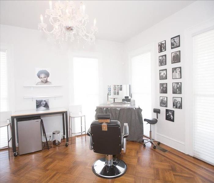 Images shows white photography studio with hardwood floors.